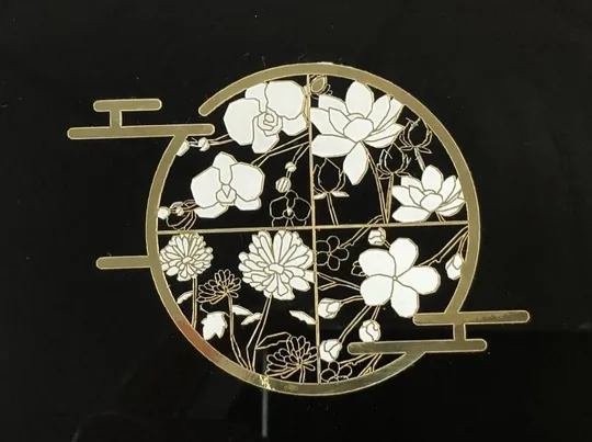 Cardboard & Paper — Laser cutting produces extremely fine shapes in silver or gold plastics.